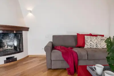 a living room with a couch and a fireplace at Downtown_Blossom with small terrace in Rome