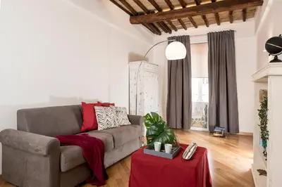 a living room with a couch and a table at Downtown_Blossom with small terrace in Rome