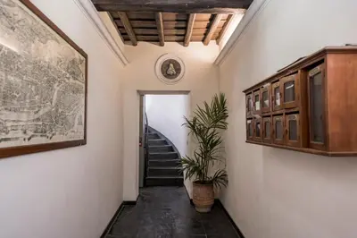 a hallway with a staircase and a painting and a plant at Downtown_Blossom with small terrace in Rome