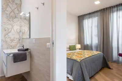 a small bedroom with a bed and a bathroom at Downtown_Blossom with small terrace in Rome