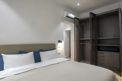 a bedroom with a large bed and a closet at Dimoro Suite in Rome