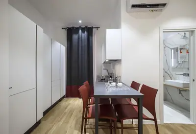 a kitchen and dining room with a table and chairs at Dimoro Suite in Rome