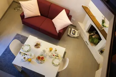 a living room with a white table and a couch at Margana Tower in Rome