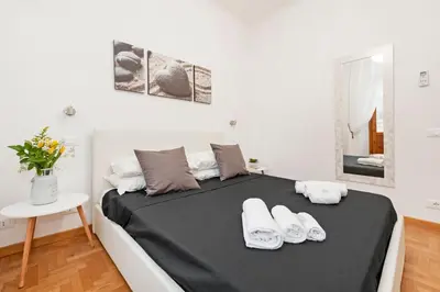a bedroom with a bed with white shoes on it at White Flat Labicana in Rome
