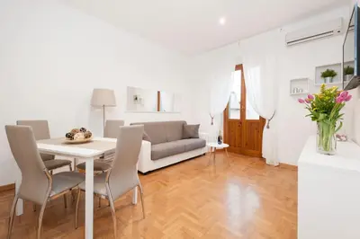 a living room with a table and chairs and a couch at White Flat Labicana in Rome