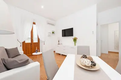 a white living room with a table and a couch at White Flat Labicana in Rome