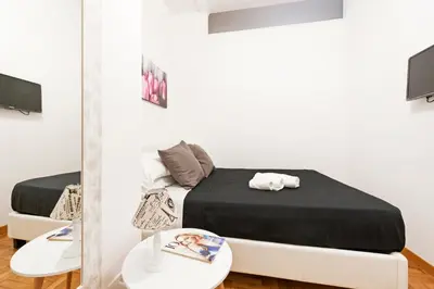 a bedroom with a bed and a mirror at White Flat Labicana in Rome