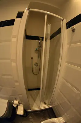 a glass shower in a bathroom with a toilet at Petit Bijou de Rome Vatican-Trastevere in Rome