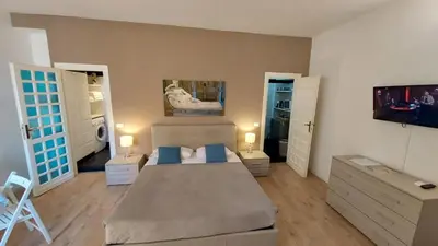 a bedroom with a bed with blue pillows on it at Petit Bijou de Rome Vatican-Trastevere in Rome