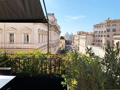 a view of a city from a balcony with plants at Casa Terrazza Colosseo in Rome