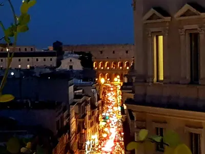 a view of a city at night with lights at Casa Terrazza Colosseo in Rome