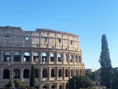 a building with a tree in front of it at Casa Terrazza Colosseo in Rome