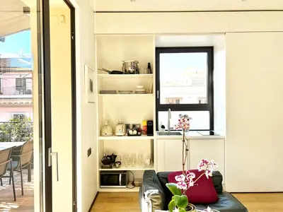 a living room with a couch and a window at Casa Terrazza Colosseo in Rome