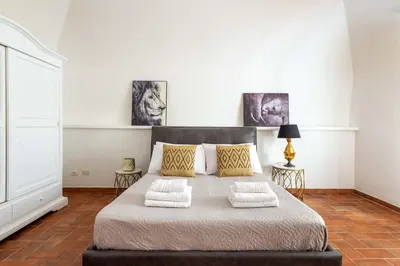a bedroom with a bed with a mirror and a table at Navona 7 Suite in Rome
