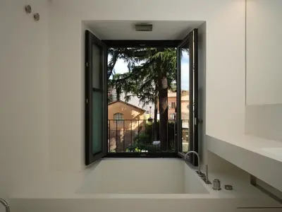 a bathroom with a window and a bath tub at Rhinoceros in Rome