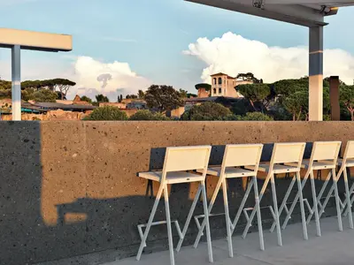 a row of chairs sitting next to a wall at Rhinoceros in Rome
