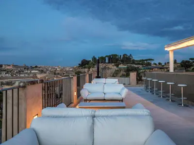 a row of white chairs sitting on a balcony at Rhinoceros in Rome