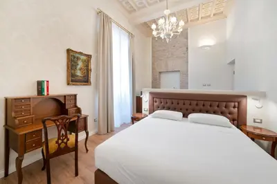 a bedroom with a bed and a desk and a chandelier at Pantheon Escape in Rome
