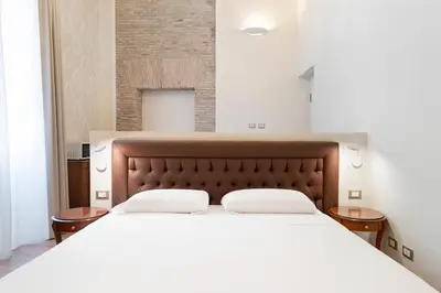 a bedroom with a large bed with white sheets at Pantheon Escape in Rome