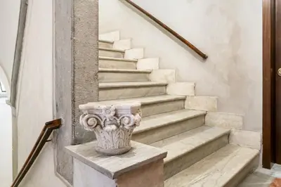 a staircase with a vase sitting on the step at Pantheon Escape in Rome