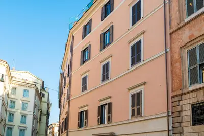 a pink building in the middle of two other buildings at Pantheon Escape in Rome