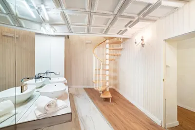 a bathroom with two sinks a toilet and a staircase at Pantheon Escape in Rome
