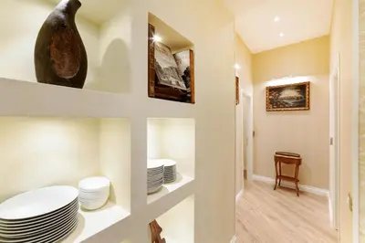 a hallway with plates on shelves in a house at Pantheon Hedonism in Rome