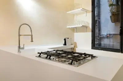 a kitchen counter with a stove and a sink at Pantheon Hedonism in Rome