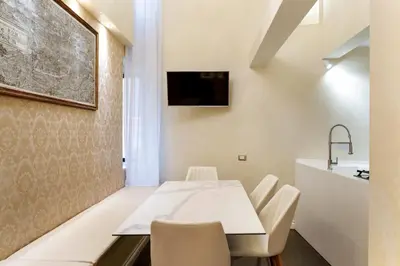 a kitchen and dining room with a table and chairs at Pantheon Hedonism in Rome