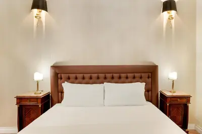 a bedroom with a large bed with two night stands at Pantheon Hedonism in Rome