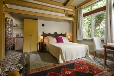 a bedroom with a bed and a large window at Palm Gallery Hotel in Rome