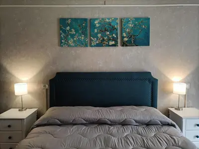 a bedroom with a bed with three paintings on the wall at Rossi Hotel in Rome