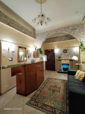 a living room with a couch and a fireplace at Rossi Hotel in Rome
