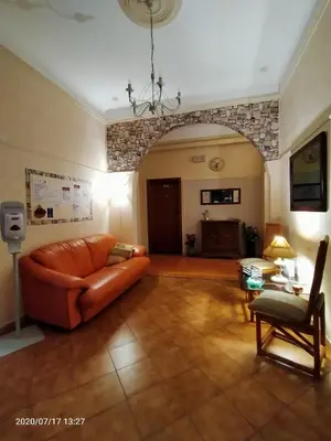 a living room with a couch and a chair at Rossi Hotel in Rome