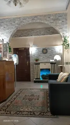 a living room with a couch and a fireplace at Rossi Hotel in Rome