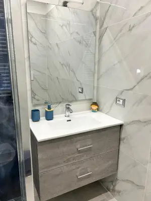 a bathroom with a sink and a mirror at San Peter Lory's Aparts in Rome