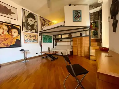 a bedroom with a bed and a desk in a room at Ugo Foscolo in Rome