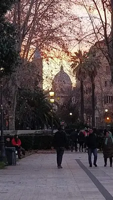 a group of people walking down a sidewalk in a city at Ugo Foscolo in Rome