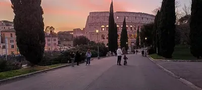 a group of people walking down a street in front of a building at Ugo Foscolo in Rome