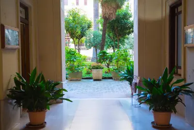 an empty hallway with potted plants in a building at La 