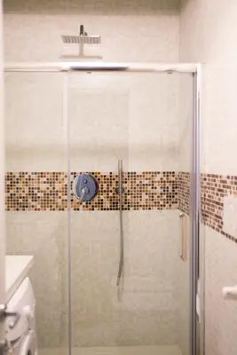 a shower with a glass door in a bathroom at La 