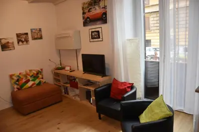 a living room with two chairs and a desk with a television at La 