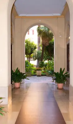 an open hallway with potted plants in a building at La 