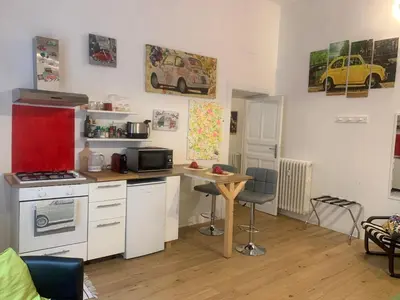 a kitchen with a counter and a table in a room at La 