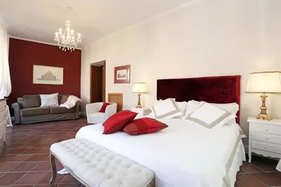 a bedroom with a large white bed with red pillows at Daplace - Gaia Apartment in Rome