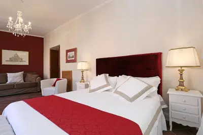 a bedroom with a large bed with a red blanket at Daplace - Gaia Apartment in Rome