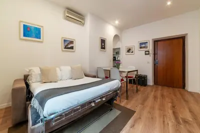 a bedroom with a bed and a table and chairs at Avignonesi 04 - FromHometoRome in Rome