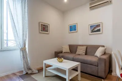 a living room with a couch and a table at Avignonesi 04 - FromHometoRome in Rome