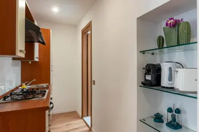 a small kitchen with a stove and a sink at Avignonesi 04 - FromHometoRome in Rome