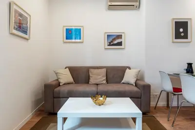 a living room with a couch and a table at Avignonesi 04 - FromHometoRome in Rome